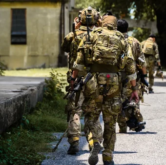 Security team moving through urban environment during operational deployment