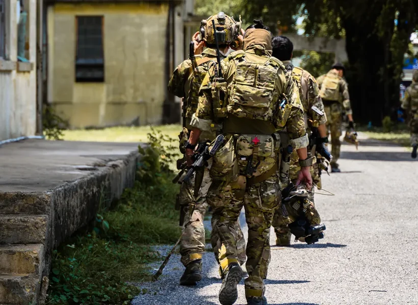 Security team moving through urban environment during operational deployment