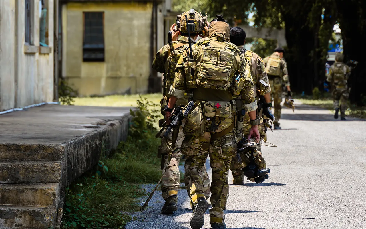 Security team moving through urban environment during operational deployment