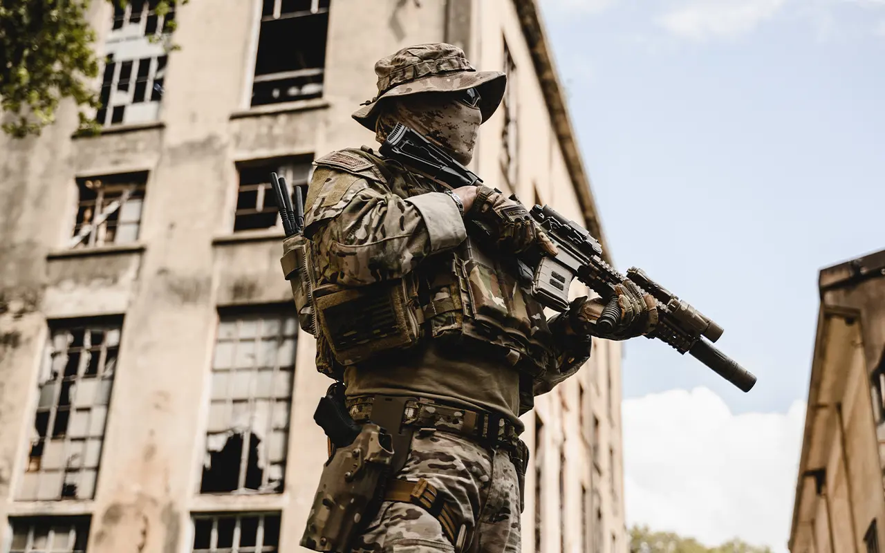 Security operator with rifle securing urban structure in high-risk environment
