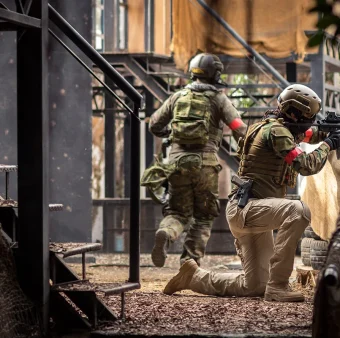 Tactical security team performing close-quarters movement in an urban training environment