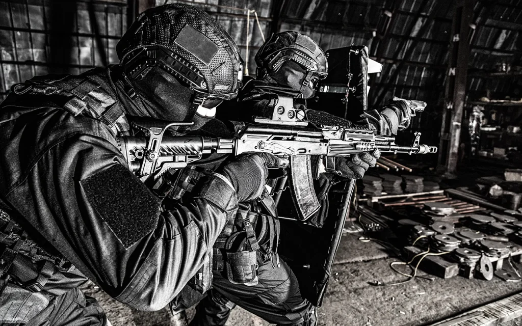 Tactical security team conducting close-quarters entry operation with ballistic shield