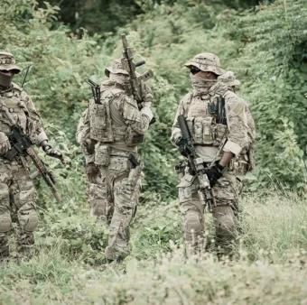 Security team performing patrol and reconnaissance in dense vegetation environment