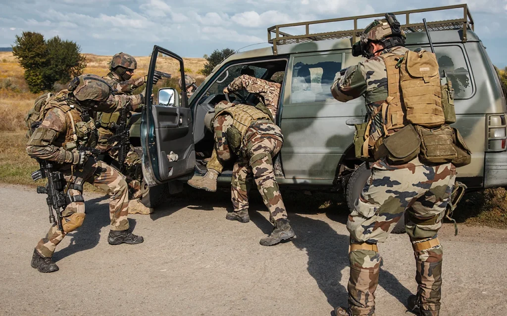 Elite security team conducting vehicle interdiction and protective operation in a high-risk environment