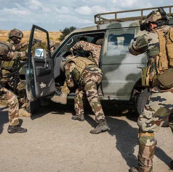 Elite security team conducting vehicle interdiction and protective operation in a high-risk environment